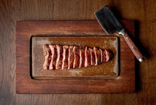 Flat Iron steak cut on a board