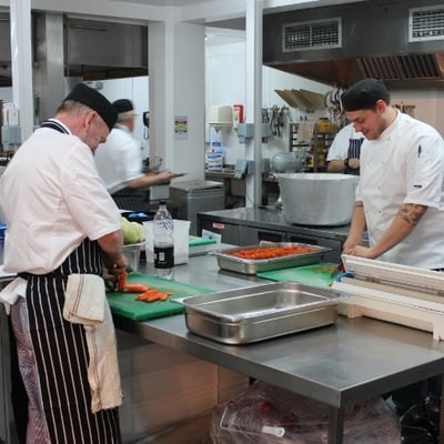 2 Chefs preparing food